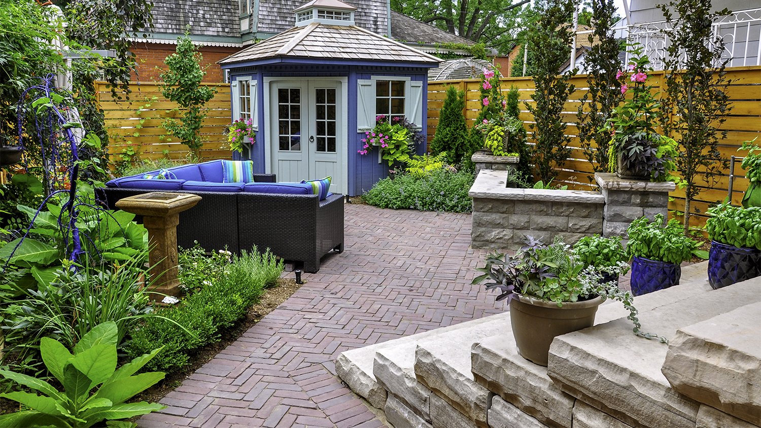 lush garden with herringbone brick paver